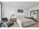 Contemporary main bedroom with chair, large mirror, neutral tones, and a shark artwork at 5120 Marina Way # 15005, Tampa, FL 33611