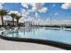 Inviting pool area with lounge chairs, sun umbrellas and tropical palm trees offering a serene outdoor experience at 5120 Marina Way # 15005, Tampa, FL 33611