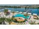 Stunning aerial view of the resort-style pool, cabanas, and lush landscaping alongside a picturesque marina at 5120 Marina Way # 15005, Tampa, FL 33611