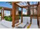 Upscale pool deck area featuring shaded lounge chairs with pergolas and lush landscaping, providing a relaxing outdoor oasis at 5120 Marina Way # 15005, Tampa, FL 33611