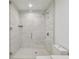 Modern bathroom shower featuring gray marble tiling and a glass door at 5120 Marina Way # 15005, Tampa, FL 33611