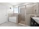 Well-lit bathroom featuring a tub, glass-enclosed shower, and stylish fixtures at 537 Ocean Spray Dr, Ruskin, FL 33570