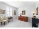 Well-lit bedroom with a yellow chair, antique furnishings, and decorative artwork at 537 Ocean Spray Dr, Ruskin, FL 33570