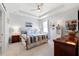 Comfortable bedroom with a brass bed, ceiling fan, and soft lighting, creating a relaxing retreat at 537 Ocean Spray Dr, Ruskin, FL 33570