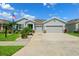 Charming single-story home featuring a well-manicured lawn, Florida landscaping, and a two-car garage at 537 Ocean Spray Dr, Ruskin, FL 33570