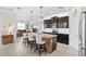 Open kitchen features dark wood cabinets, granite counters, island with seating, and stainless steel appliances at 537 Ocean Spray Dr, Ruskin, FL 33570