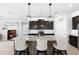 Open kitchen with a large center island, seating for three, modern appliances, and pendant lighting at 537 Ocean Spray Dr, Ruskin, FL 33570