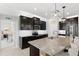 Modern kitchen features granite countertops, stainless steel appliances and dark cabinetry at 537 Ocean Spray Dr, Ruskin, FL 33570