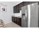 Stylish kitchenette featuring modern appliances, granite countertops, and dark cabinetry at 537 Ocean Spray Dr, Ruskin, FL 33570