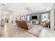 Spacious living room featuring a plush rug, comfortable seating, tray ceilings, and abundant natural light at 537 Ocean Spray Dr, Ruskin, FL 33570