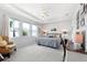 Serene main bedroom featuring tray ceilings, ample natural light, and a cozy seating area at 537 Ocean Spray Dr, Ruskin, FL 33570
