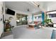 Well decorated patio with a tv, ceiling fan, blue curtains, and a sliding glass door at 537 Ocean Spray Dr, Ruskin, FL 33570