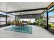 Inviting covered patio with a dining table, fan, and string lights, creating a perfect space for entertaining at 537 Ocean Spray Dr, Ruskin, FL 33570