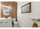 Stylishly decorated powder room with a unique wood-look accent wall, modern fixtures and decorative accents at 537 Ocean Spray Dr, Ruskin, FL 33570