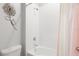 Bright tiled shower and tub combo with a decorative flower on the wall and a colorful shower curtain at 537 Ocean Spray Dr, Ruskin, FL 33570