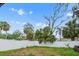 Well-maintained backyard featuring a white privacy fence and several mature trees at 5614 Bay Boulevard, Port Richey, FL 34668