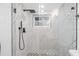Bathroom with marble style shower, black hardware, and geometric tile at 5614 Bay Boulevard, Port Richey, FL 34668