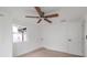 Well-lit bedroom with a ceiling fan and neutral paint, creating a cozy atmosphere at 5614 Bay Boulevard, Port Richey, FL 34668