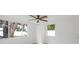 Bright bedroom featuring large windows offering ample natural light and a modern ceiling fan at 5614 Bay Boulevard, Port Richey, FL 34668