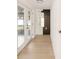 Bright hallway features light wood floors, white walls, and a unique round mirror at 5614 Bay Boulevard, Port Richey, FL 34668
