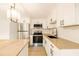Modern kitchen with stainless steel appliances, white cabinets, and light countertops at 5614 Bay Boulevard, Port Richey, FL 34668