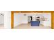 Bright living area leading to the kitchen with wooden beams and light wood floors at 5614 Bay Boulevard, Port Richey, FL 34668