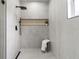 Modern bathroom boasts gray tile, a sleek shower with black fixtures, and a convenient shower niche at 5628 Terrain De Golf Dr, Lutz, FL 33558