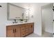 Elegant bathroom featuring double sinks, wood vanity, and a large framed mirror at 5628 Terrain De Golf Dr, Lutz, FL 33558