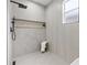 Modern bathroom boasts gray tile, a sleek shower with black fixtures, and a convenient shower niche at 5628 Terrain De Golf Dr, Lutz, FL 33558