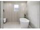 Elegant bathroom featuring a freestanding tub, gray tile, a stylish shower, and a window at 5628 Terrain De Golf Dr, Lutz, FL 33558