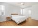 Serene bedroom with wood flooring, light neutral tones, and natural light at 5628 Terrain De Golf Dr, Lutz, FL 33558
