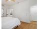 Neutral bedroom featuring wood flooring, ensuite bath, and closet at 5628 Terrain De Golf Dr, Lutz, FL 33558