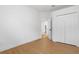 This bright, modern bedroom features wood floors and a closet; doorway to other rooms visible at 5628 Terrain De Golf Dr, Lutz, FL 33558