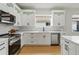 Bright kitchen features white cabinets, stainless steel appliances, and subway tile backsplash at 5628 Terrain De Golf Dr, Lutz, FL 33558