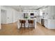 Bright kitchen with a large center island, modern white cabinetry, stainless steel appliances, and breakfast bar seating at 5628 Terrain De Golf Dr, Lutz, FL 33558
