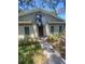 Inviting single-story home features neutral exterior paint, awning, and an easy-to-navigate walkway to the front door at 6214 Dewdrop Way # 621, Temple Terrace, FL 33617