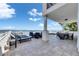 Lounge chairs surround the backyard pool with outdoor dining and serene water views at 6418 Bright Bay Ct, Apollo Beach, FL 33572
