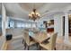 Spacious dining room featuring chandelier and view into the kitchen at 6418 Bright Bay Ct, Apollo Beach, FL 33572