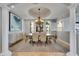 Elegant dining room featuring a tray ceiling, chandelier, and stylish decor at 6418 Bright Bay Ct, Apollo Beach, FL 33572