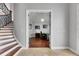 Elegant entryway features a staircase with wrought iron railing, leading to an office space with hardwood floors at 6418 Bright Bay Ct, Apollo Beach, FL 33572