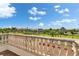 Scenic view from a balcony showing lush landscaping, neighborhood homes and a bright blue sky with scattered clouds at 6418 Bright Bay Ct, Apollo Beach, FL 33572