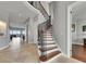 Grand foyer featuring a curved staircase with wrought iron details at 6418 Bright Bay Ct, Apollo Beach, FL 33572