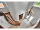 Grand foyer with a curved staircase, iron railing, chandelier, and view of the double door entryway at 6418 Bright Bay Ct, Apollo Beach, FL 33572
