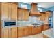 Gourmet kitchen featuring custom wood cabinetry and stylish backsplash at 6418 Bright Bay Ct, Apollo Beach, FL 33572