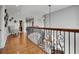 Bright second-floor landing with hardwood floors, decorative railing, and modern accents at 6418 Bright Bay Ct, Apollo Beach, FL 33572