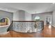 Second floor landing with decorative iron railing and view to the yard through arched window at 6418 Bright Bay Ct, Apollo Beach, FL 33572
