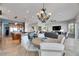Spacious living room with open floor plan, chandelier, and seamless flow to the kitchen at 6418 Bright Bay Ct, Apollo Beach, FL 33572