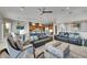 Open-concept living room shows the kitchen, staircase, and elegant furnishings at 6418 Bright Bay Ct, Apollo Beach, FL 33572
