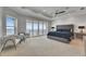 Spacious primary bedroom with water views, balcony access, seating area and a ceiling fan at 6418 Bright Bay Ct, Apollo Beach, FL 33572