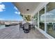 Covered outdoor patio featuring a dining table, chairs, and a glimpse of the serene waterfront and inviting pool at 6418 Bright Bay Ct, Apollo Beach, FL 33572